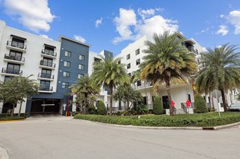 Side view of building with palm trees at Bay Village 1 Apartment in Palmetto Bay, FL
